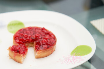 classic red berry curd tart on glod plate on table with copy space