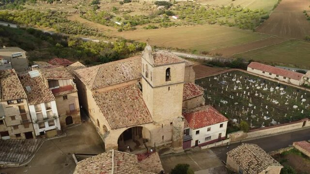 Drone view towards the clock tower and above the cemetery and the small village of Monroyo in Matarra&ntilde;a region in Spain_2
