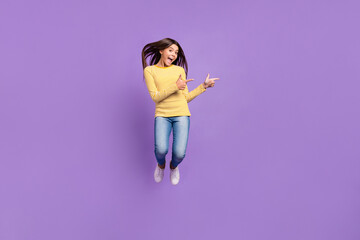 Full body photo of young excited girl indicate fingers empty space promo ads direct suggest...