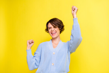 Photo of young excited girl happy positive smile celebrate win victory success fists hands isolated...