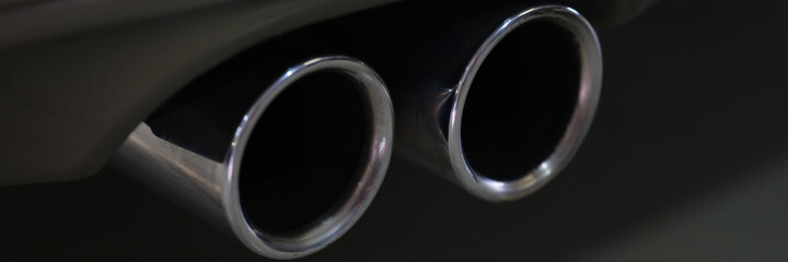 Closeup of metal exhaust pipe of sports car