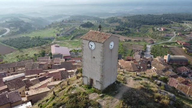 Orbital 360 drone flight of the Bell tower on top of the hill in Monroyo village in Matarra&ntilde;a region in Spain