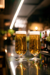 Two glasses of beer in a bar