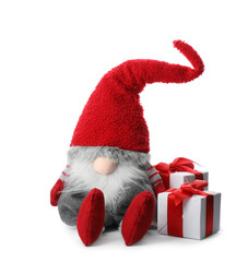 Funny Christmas gnome with gift boxes on white background