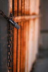 Padlock with rusty chain locking an old rusty padlock lock