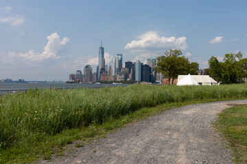 Fototapeta na wymiar Empty Curving Trail on Governors Island with a view of the Lower Manhattan New York City Skyline during Summer