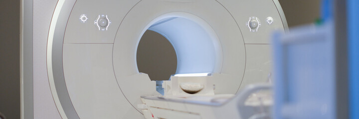 Modern magnetic resonance imaging machine standing in clinic background