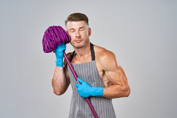 a man with a mop in his hands cleaning service posing