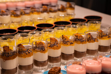 Brownie cake with ground chocolate and biscuit in a glass.