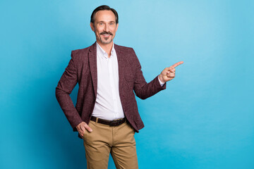 Photo of positive man indicate forefinger empty space wear red blazer isolated blue color background