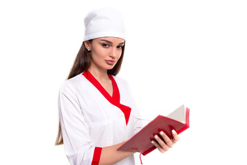 Girl doctor in a medical gown and a medical cap with a red notepad in her hands on a white...