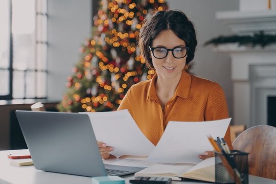 Smiling Hispanic woman employee working in office during christmas time