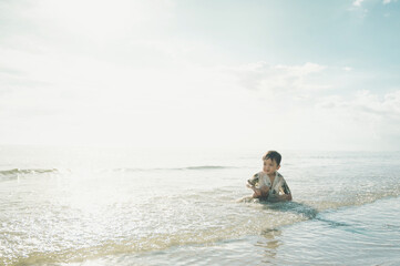 2 years old baby boy playing sand on the beach,Holidays with baby summer concept.