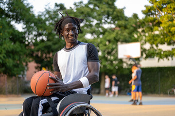 Afro American athlete on wheelchair playing basketball - sport disability concept