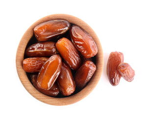 Sweet dried dates in bowl on white background, top view