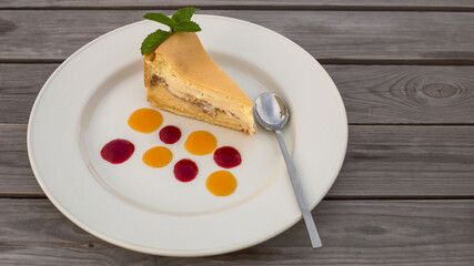 a piece of delicious fresh cake on a large plate with colorful jam drops