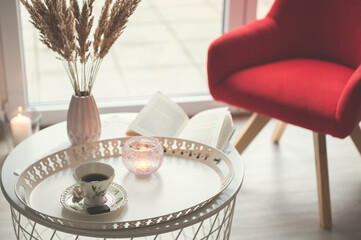 Photo of stylish white tray with black koffee and dark chocoltte and a book