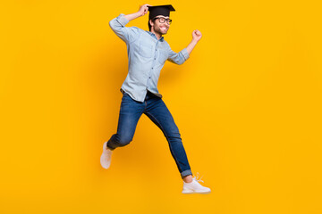 Fototapeta na wymiar Full length profile side photo of young man happy positive smile jump go run master degree isolated over yellow color background