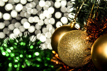 Golden Christmas tree ball and colorful tinsel