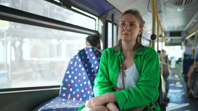 Pretty female tourist in the city bus.