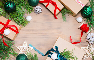 Many assorted gift boxes and pine branches on wooden background