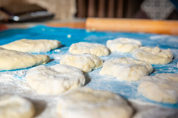 raw dough for pies on the table with flour. High quality photo
