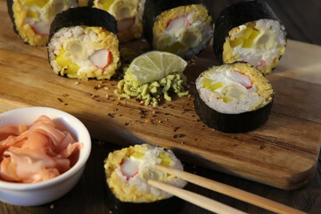 Sushi Set - Different Types of Maki Sushi and Nigiri Sushi. Served on dark wooden table.