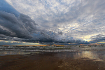 Dramatic clouds on the sea beach at sunset of the day