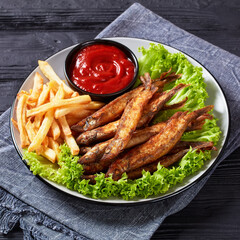 crispy fried capelin with lettuce, french fries