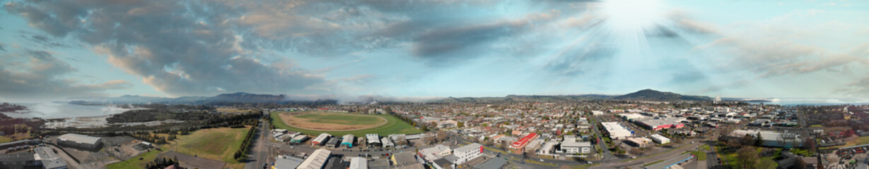 Panoramic aerial view of Rotorua landscape and geysers smoke, New Zealand from drone