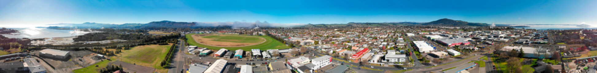 Fototapeta na wymiar Panoramic aerial view of Rotorua landscape and geysers smoke, New Zealand from drone