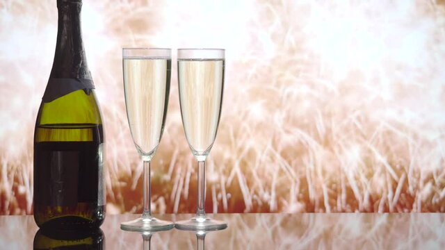 New Years Eve. Image of a bottle of champagne and two glasses of champagne against the background of fireworks. Holiday.