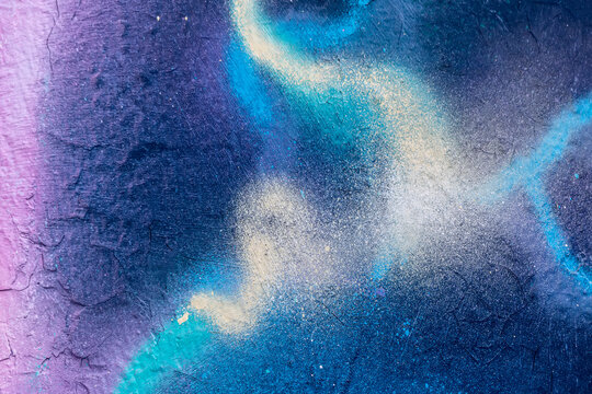 Beautiful bright colorful street art graffiti background. Abstract creative spray drawing fashion colors on the walls of the city. Urban Culture, purple , crimson, blue texture