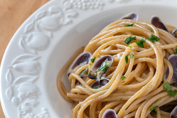Close up of a plate with spaghetti and tellinas clams.