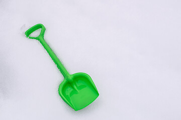 toy green shovel in the snow