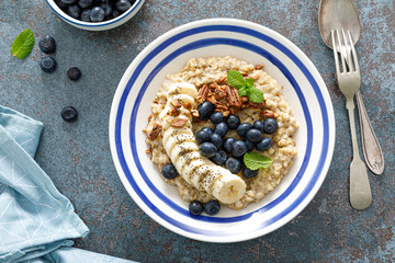 Oatmeal with fresh blueberries and pecans and banana