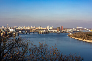 View of the city of Kiev and the Dnieper river with bridges, houses and parks.