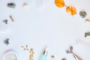 Trendy face care cosmetics background. Serum, patches, massager and sunglasses. Natural eco forest moss and oats. Hyaluronic and moisturizing gel. Dermatology cosmetics. Copy space. Gradient white