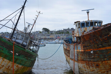 Fototapeta na wymiar Camaret sur Mer, France, old rusty fisher boats rotten in the harbor