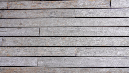 the wooden plank texture of the boardwalk. weathered board in faded brown color. the shabby surface for nature background texture collection.