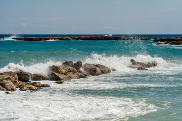 Sea waves break at stones during storm