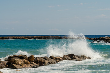 Sea waves break at stones during storm