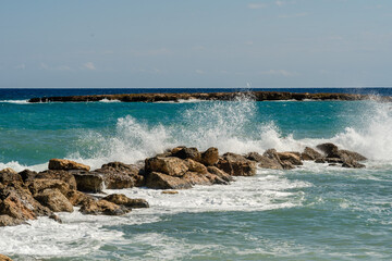 Sea waves break at stones during storm