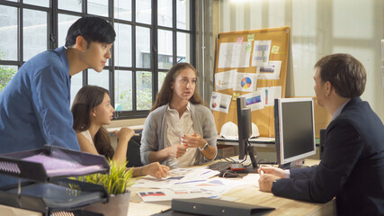 A group of multi ethnic business team talk, communicate, discuss, and work in meeting room in office, present ideas with a computer technology device to colleagues. People lifestyle. Corporation