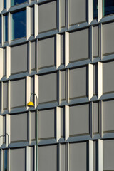 Urban minimalist photography. Modern Facade and Office building with yellow street light pole.