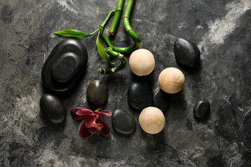 Spa composition with stones and balls on grunge background