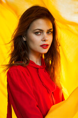 cheerful woman in red dress makeup yellow cloth posing