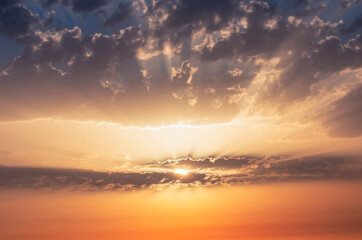 Fototapeta na wymiar Sun rays at dawn through the clouds.