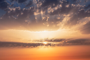 Sun rays at dawn through the clouds.