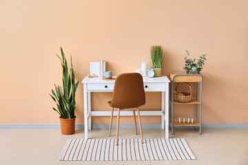 Stylish workplace with alarm clock in interior of room